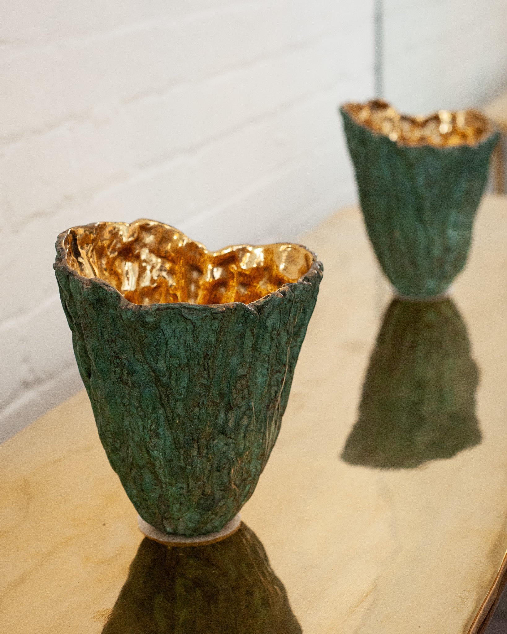 CONTEMPORARY GREEN PATINATED BRASS WOOD BARK VASE WITH POLISHED BRASS INTERIOR