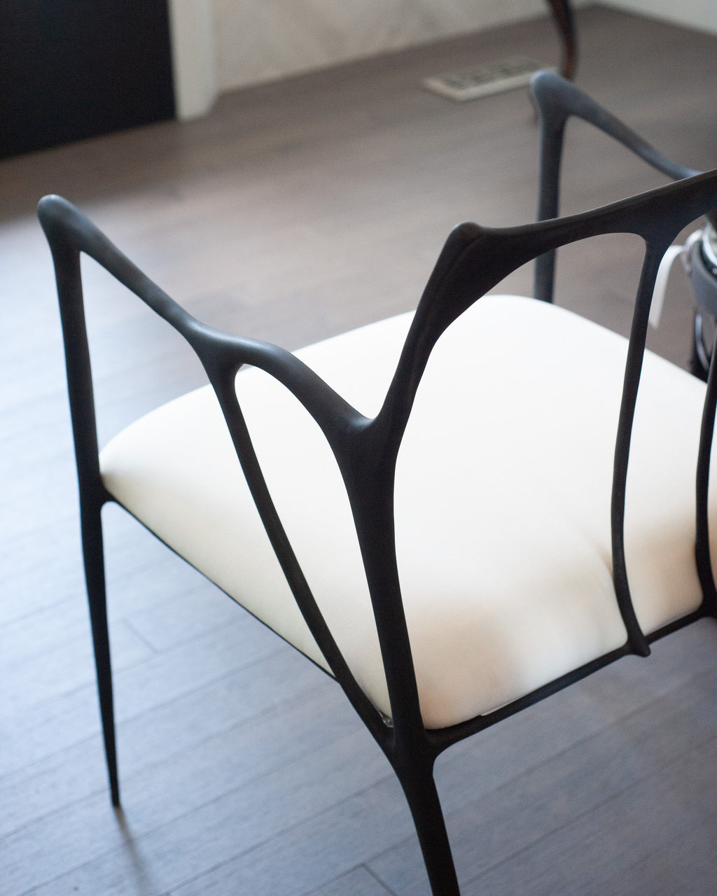 CONTEMPORARY BLACKENED CAST BRASS SCULPTURAL ARMCHAIR WITH CALICO SEAT