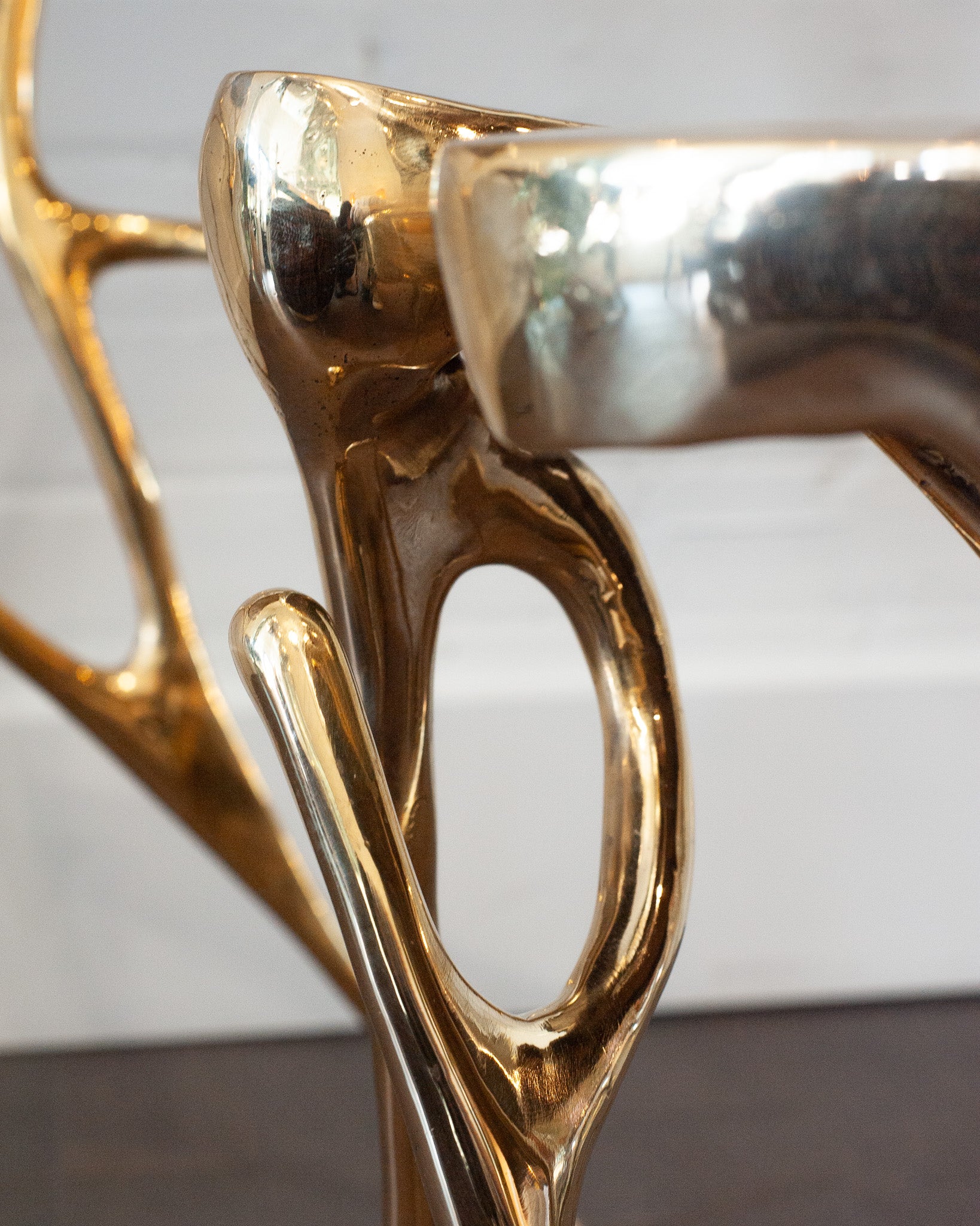 CONTEMPORARY POLISHED CAST BRASS SCULPTURAL SIDE TABLE