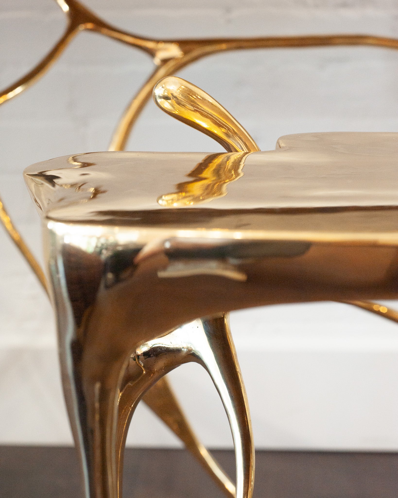 CONTEMPORARY POLISHED CAST BRASS SCULPTURAL SIDE TABLE