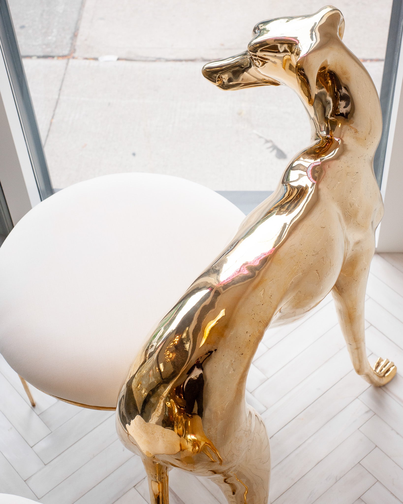 CONTEMPORARY PAIR OF POLISHED CAST BRASS GREYHOUND CHAIRS