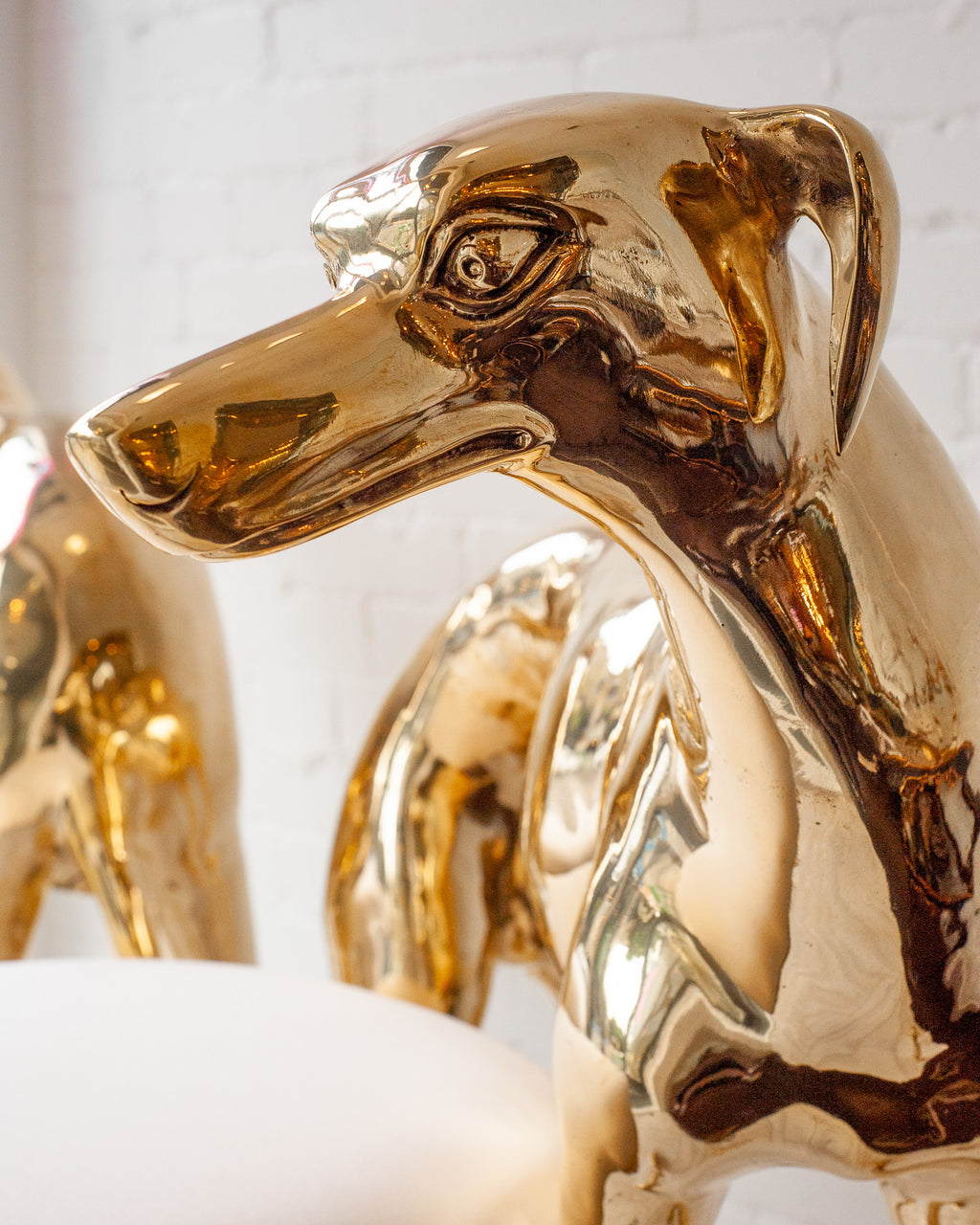 CONTEMPORARY PAIR OF POLISHED CAST BRASS GREYHOUND CHAIRS