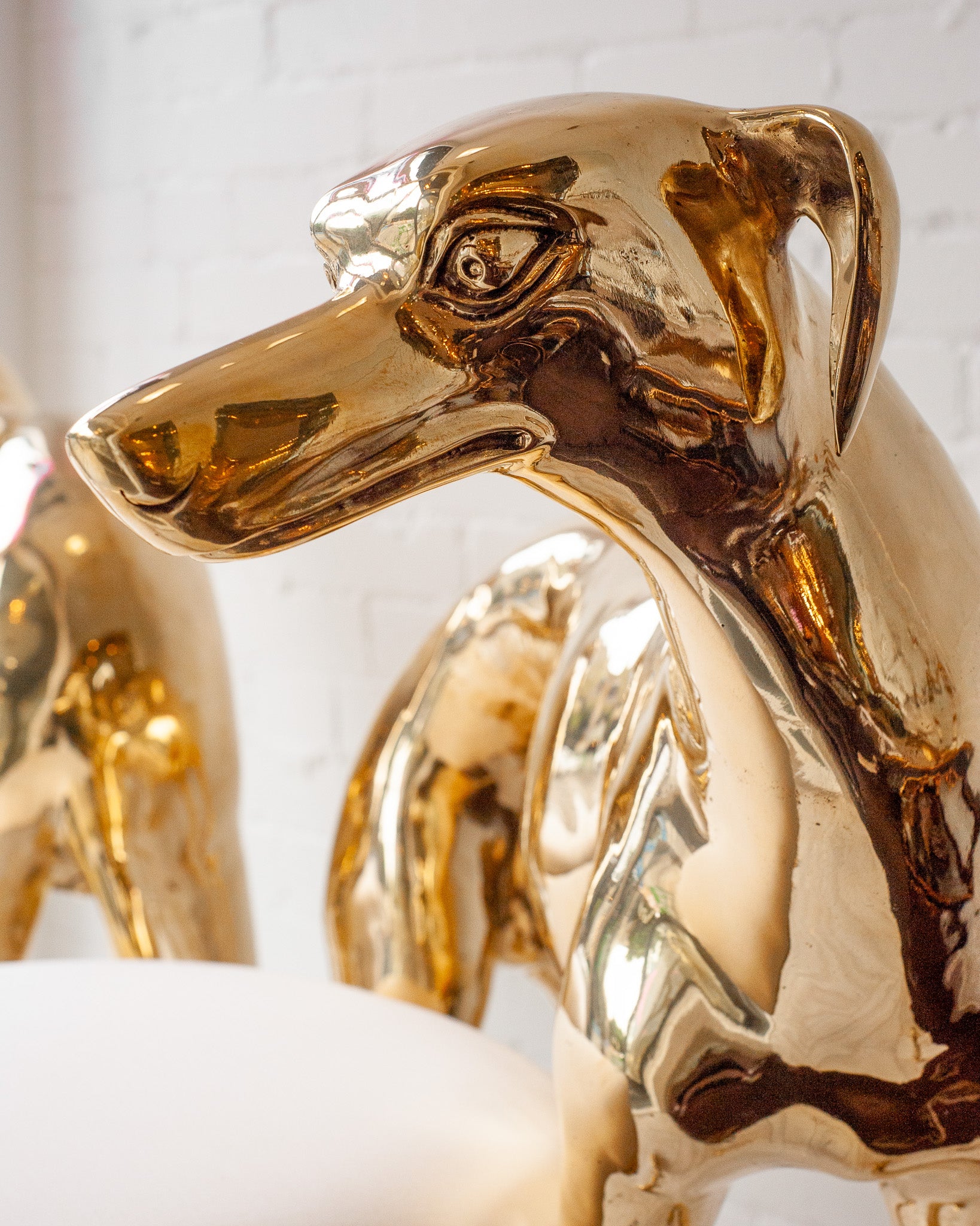 CONTEMPORARY PAIR OF POLISHED CAST BRASS GREYHOUND CHAIRS