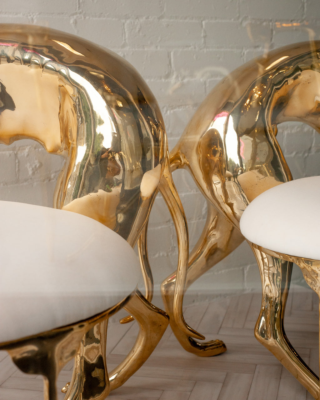 CONTEMPORARY PAIR OF POLISHED CAST BRASS GREYHOUND CHAIRS