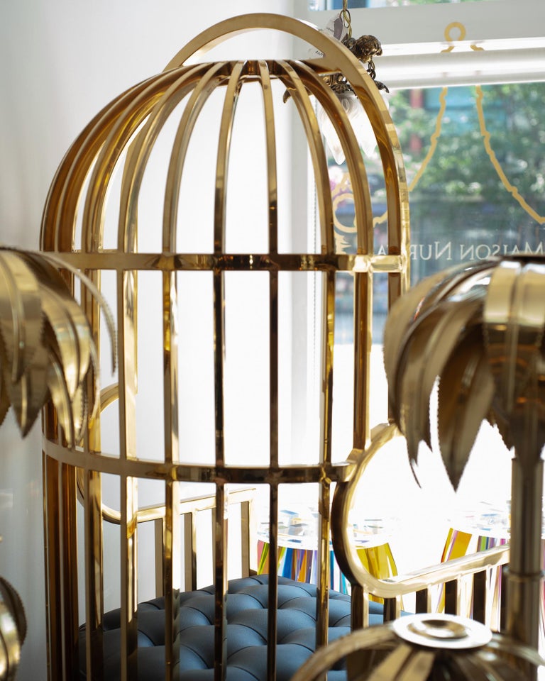 CONTEMPORARY POLISHED BRASS AND LEATHER UPHOLSTERED BIRDCAGE CHAIR
