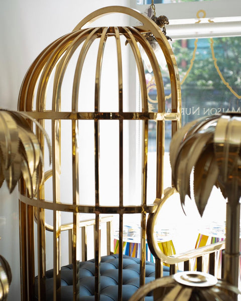 CONTEMPORARY POLISHED BRASS AND LEATHER UPHOLSTERED BIRDCAGE CHAIR