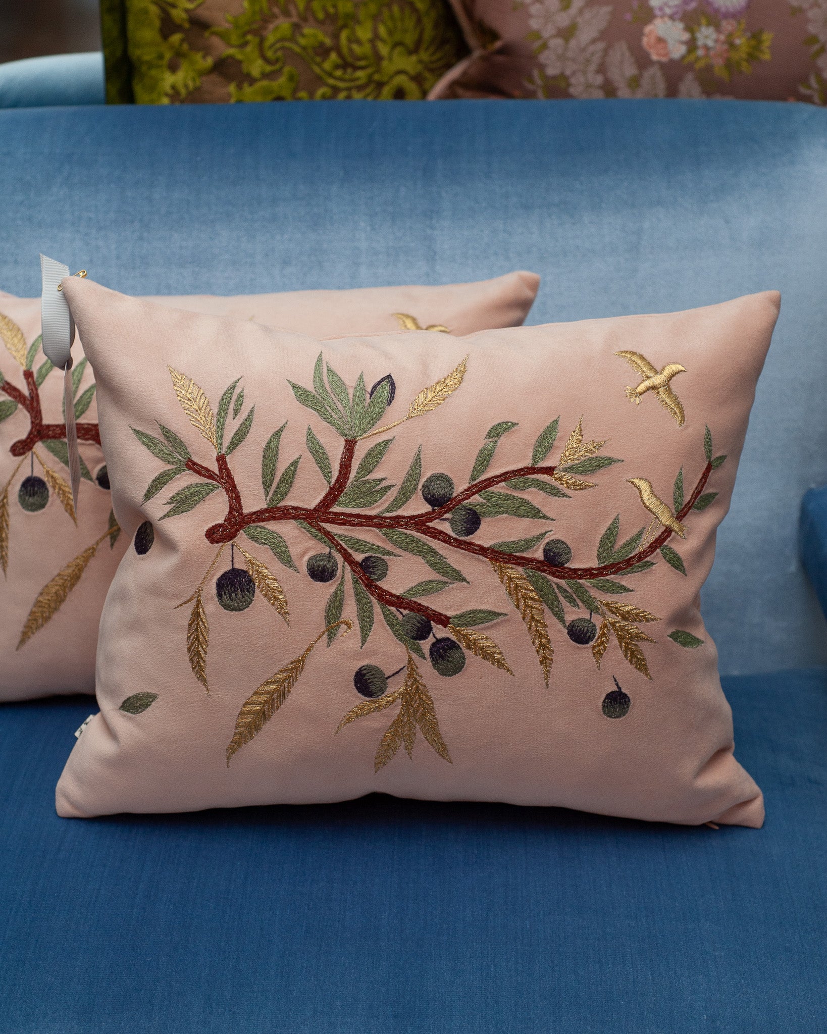 CONTEMPORARY EMBROIDERED PILLOW ON SOFT PINK ULTRASUEDE WITH DOVE & OLIVE BRANCH