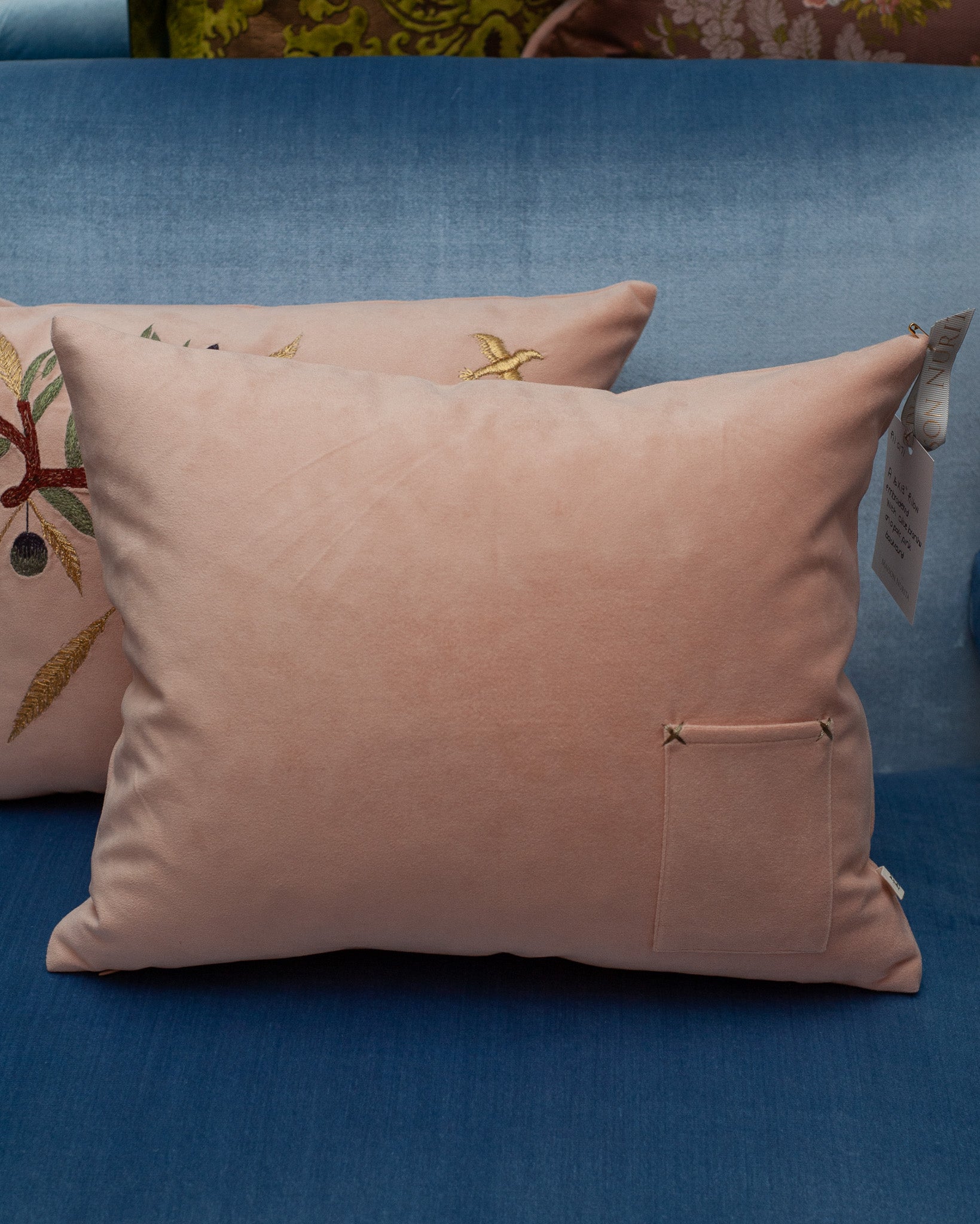 CONTEMPORARY EMBROIDERED PILLOW ON SOFT PINK ULTRASUEDE WITH DOVE & OLIVE BRANCH
