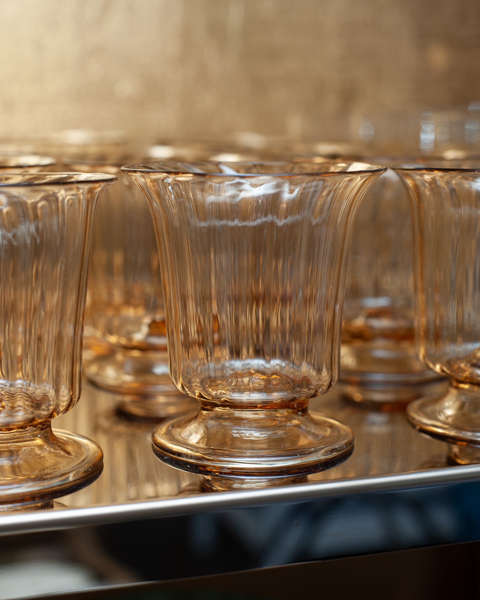 CONTEMPORARY SET OF 12 FLUTED MURANO GLASS TUMBLERS IN SOFT AMBER