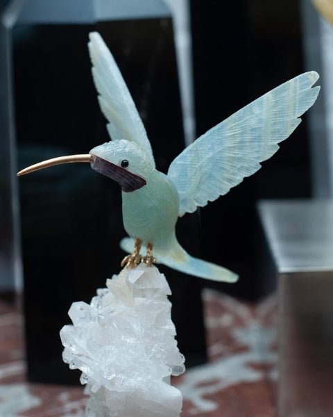 AQUAMARINE HUMMINGBIRD SCULPTURE ON ROCK CRYSTAL AND BLUE ONYX MINERAL BASE