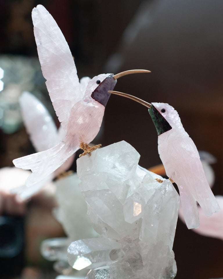 A PAIR OF ROSE QUARTZ HUMMINGBIRDS ON ROCK CRYSTAL AND MARBLE MINERAL BASE