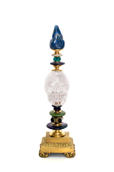 A one of a kind sculptural objet consisting of a carved Rock Crystal skull with  semi-precious stones and antique bronze components on a bronze pedestal by German artist, Dupont. At Maison Nurita we try and elevate our accessories by placing them on a cube or enclosing them in a dome.