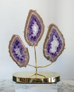 A sculpture of 3 Amethyst slices attached to a custom Studio Maison Nurita brass base. Amethyst is a remarkable stone of spirituality and contentment, it stills the mind and enhances a meditative state. This objet will add a touch of drama to any space.