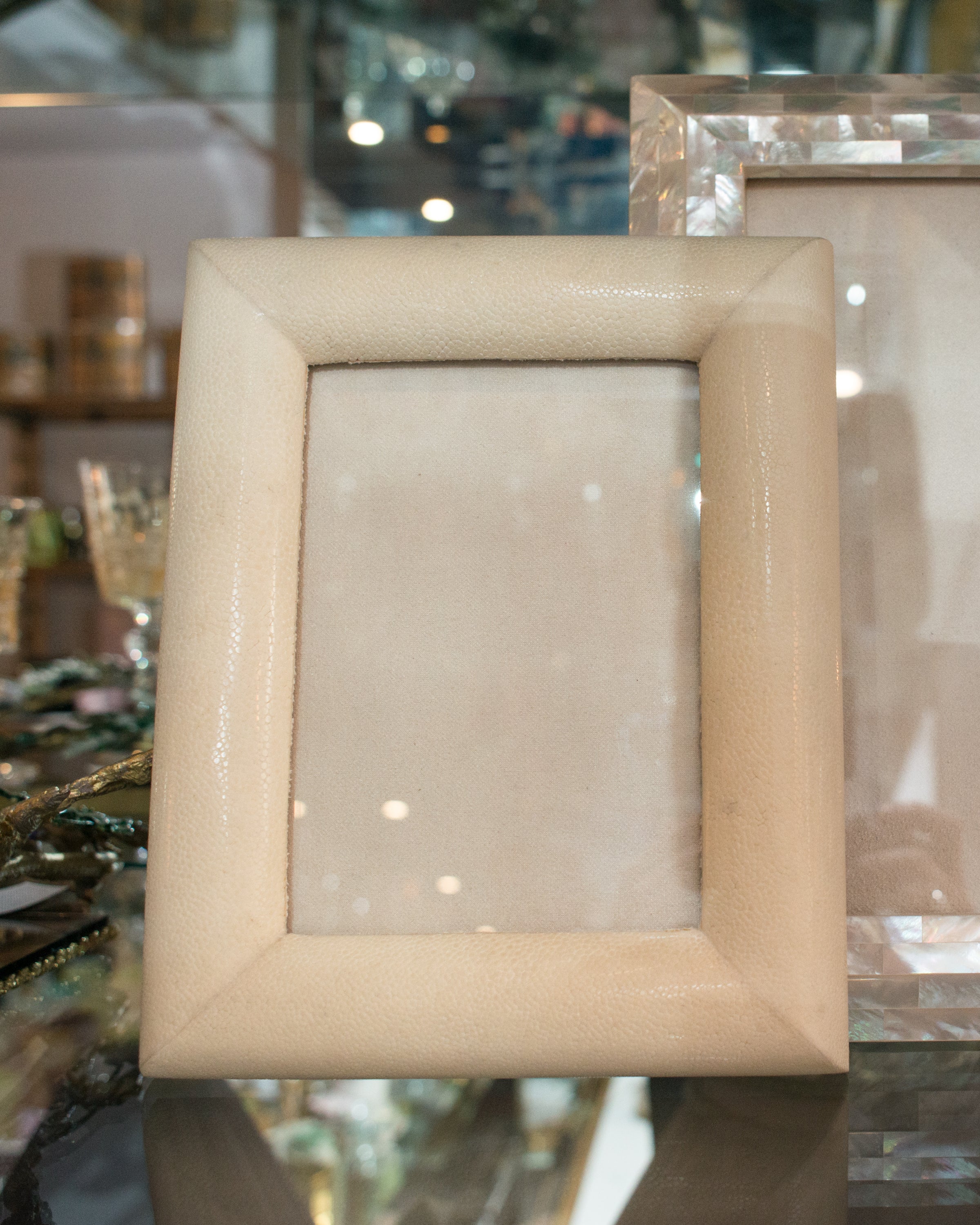 A medium picture frame in crème Shagreen & walnut,  backed in suede.