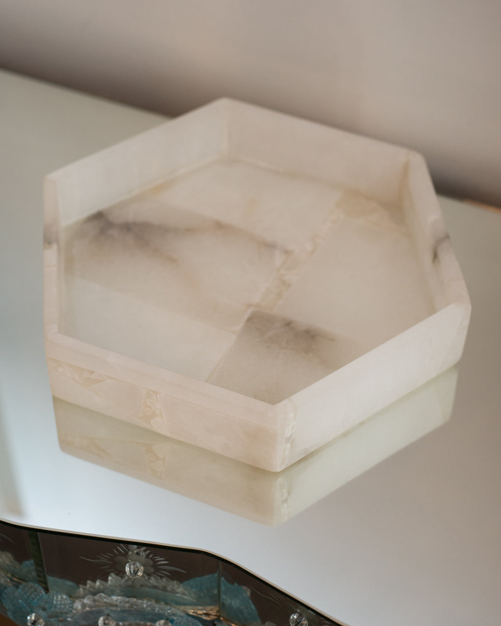 A contemporary hexagon selenite tray, perfect for a bathroom.