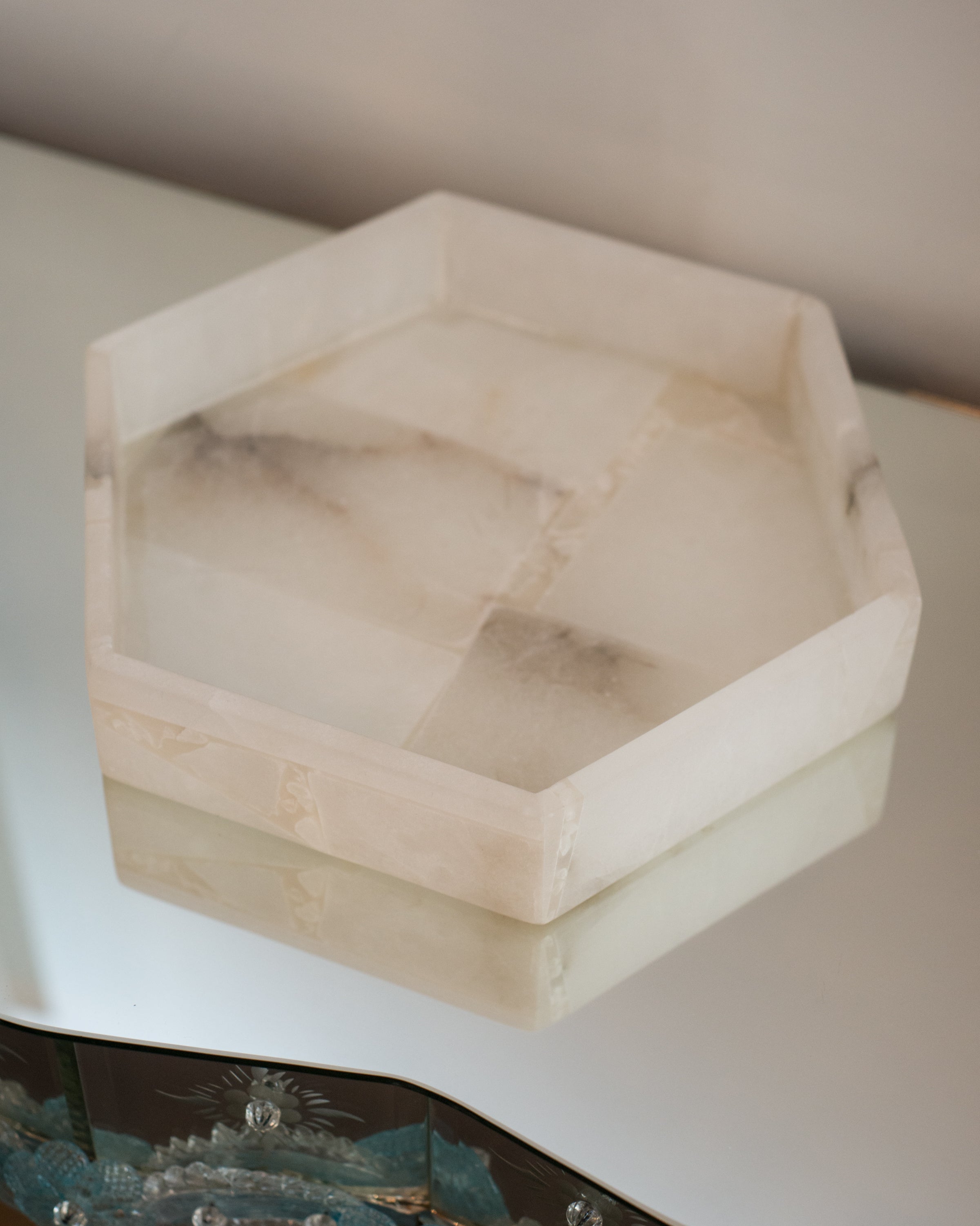 A contemporary hexagon selenite tray, perfect for a bathroom.