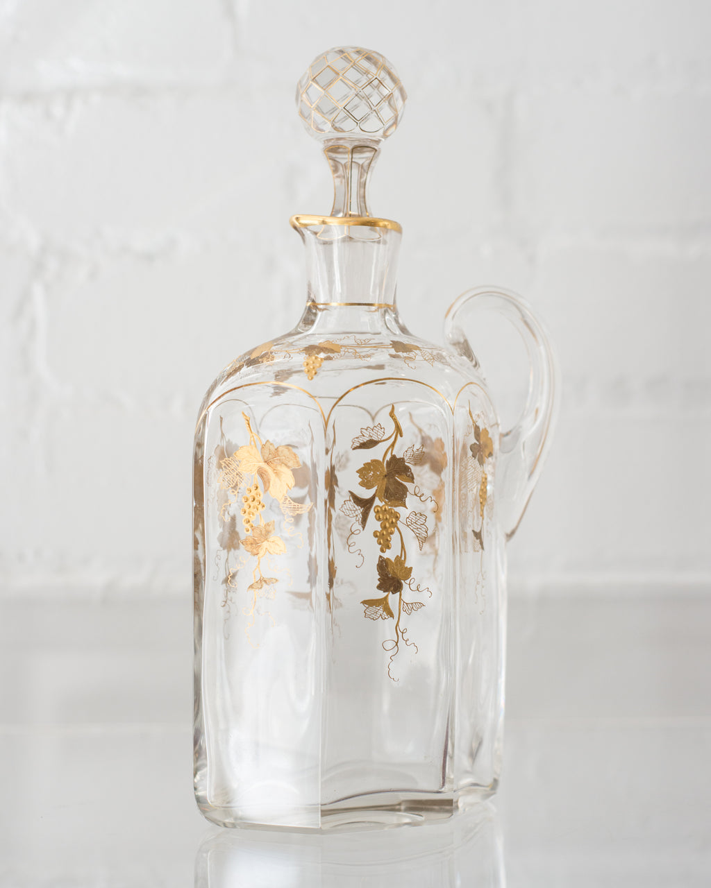 ANTIQUE GLASS AND GOLD DECANTER WITH GRAPES