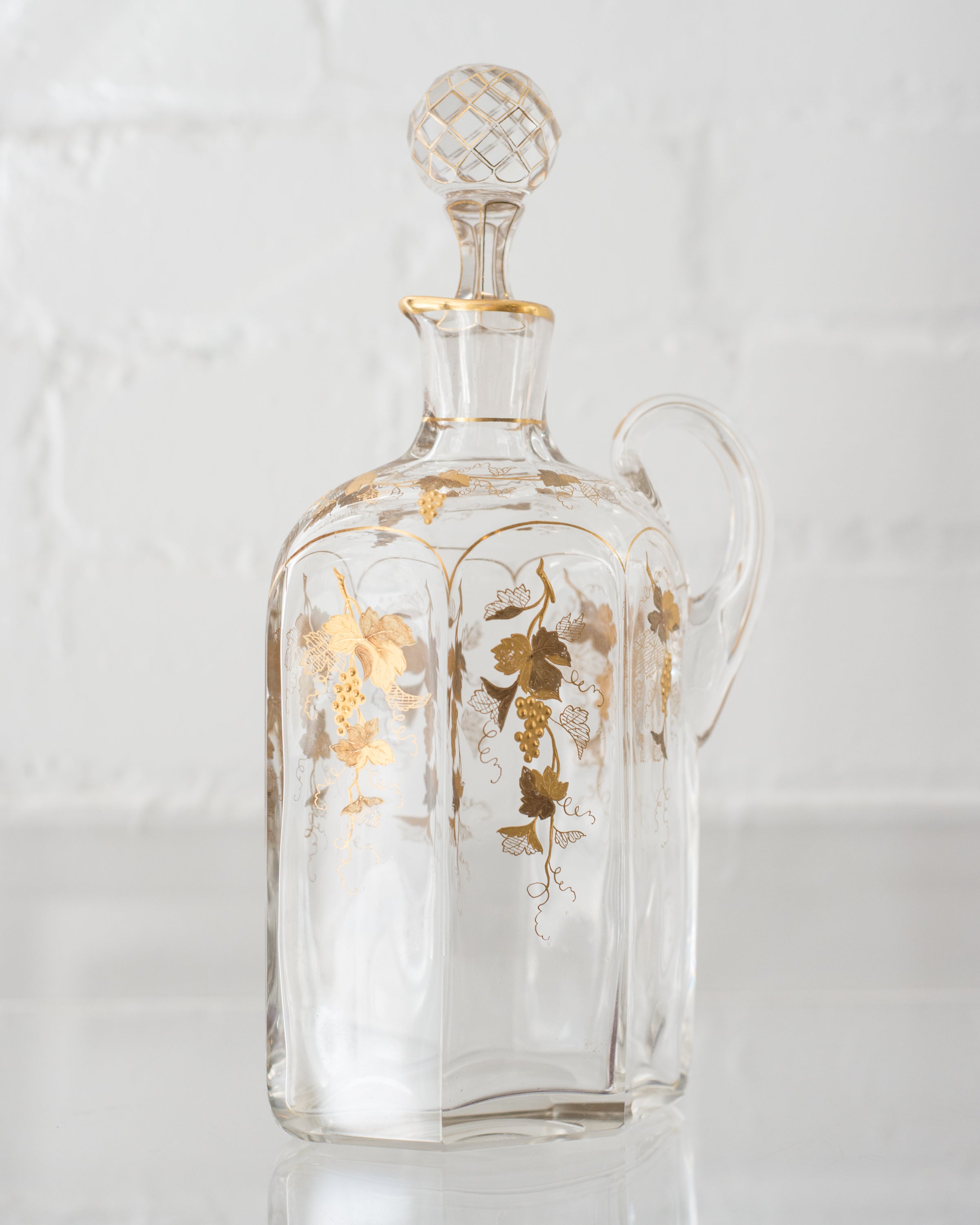 ANTIQUE GLASS AND GOLD DECANTER WITH GRAPES