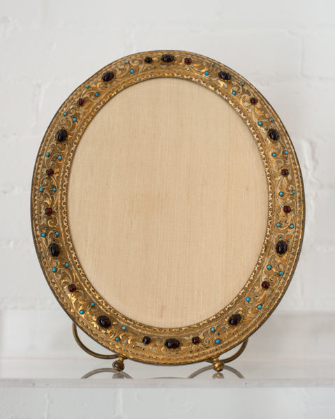 An extremely decorative Antique bronze frame with semi-precious cabochons.