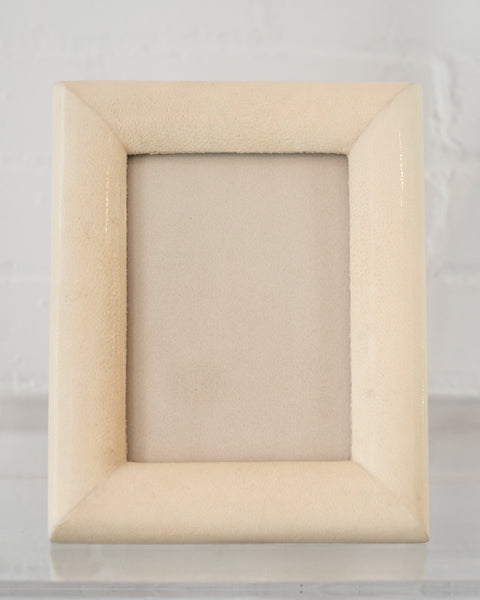 A medium picture frame in crème Shagreen & walnut,  backed in suede.