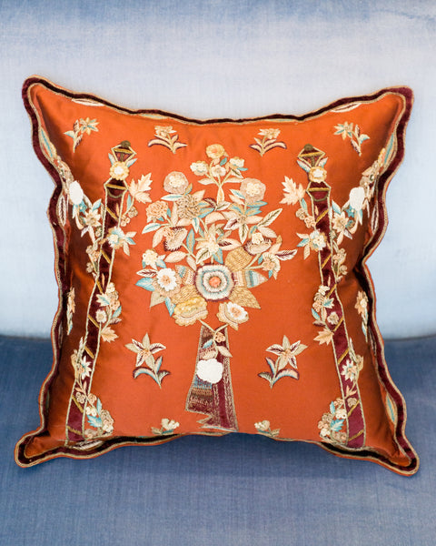 FLORAL METALLIC EMBROIDERY ON A RED SATIN PILLOW