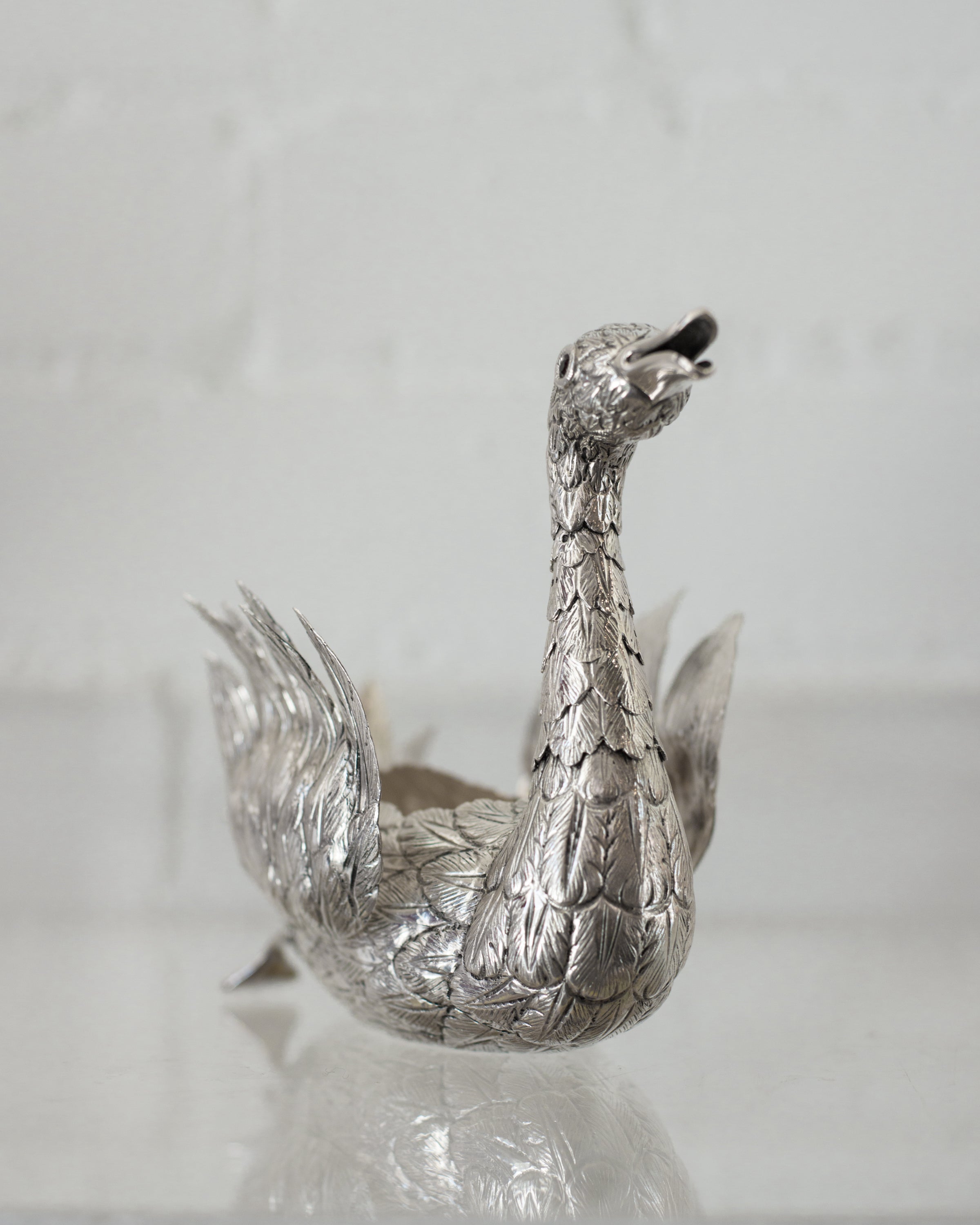 A CONTEMPORARY HAND CHASED 925 STERLING SILVER SWAN