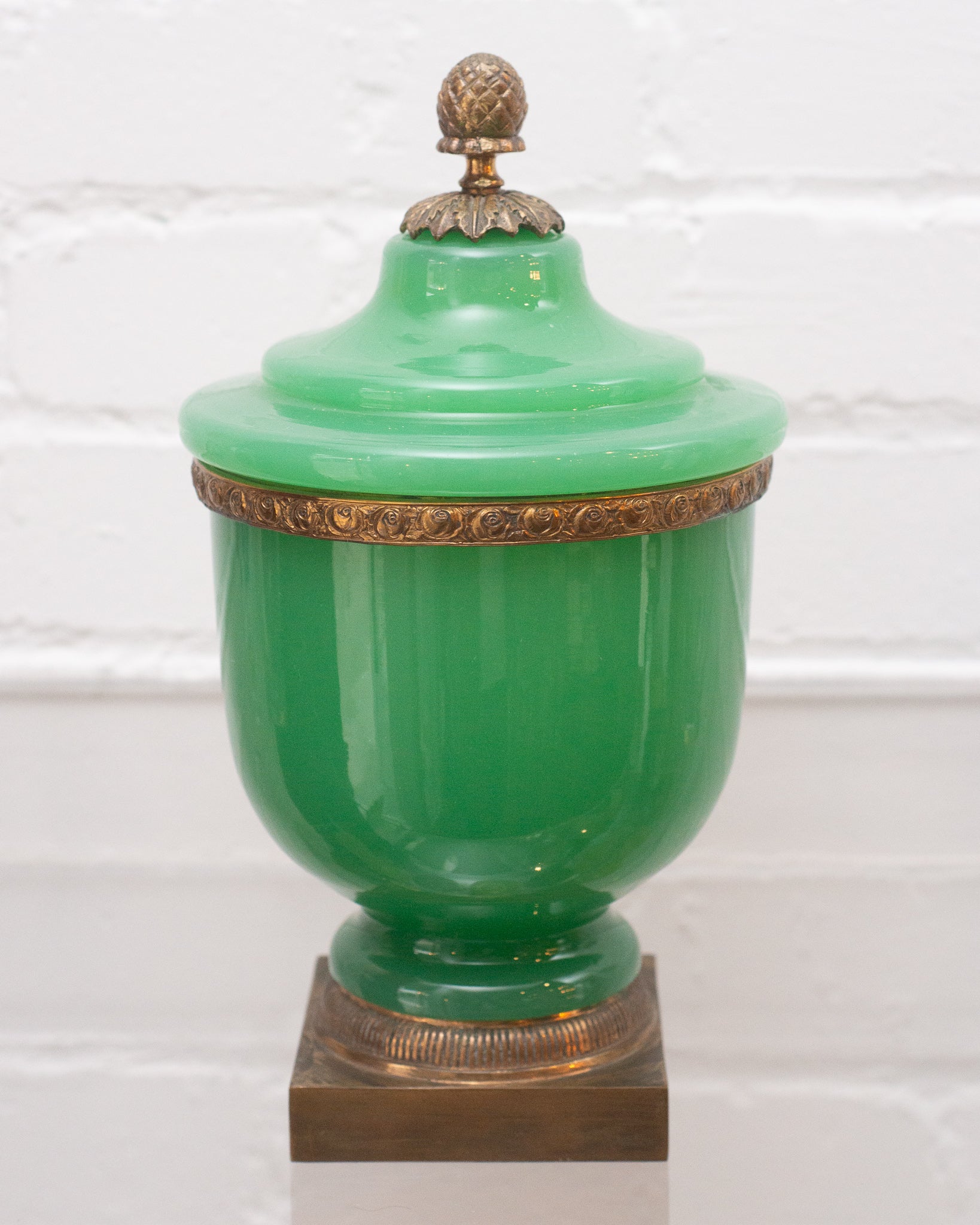 ANTIQUE GREEN OPALINE COVERED JAR WITH ACORN FINIAL