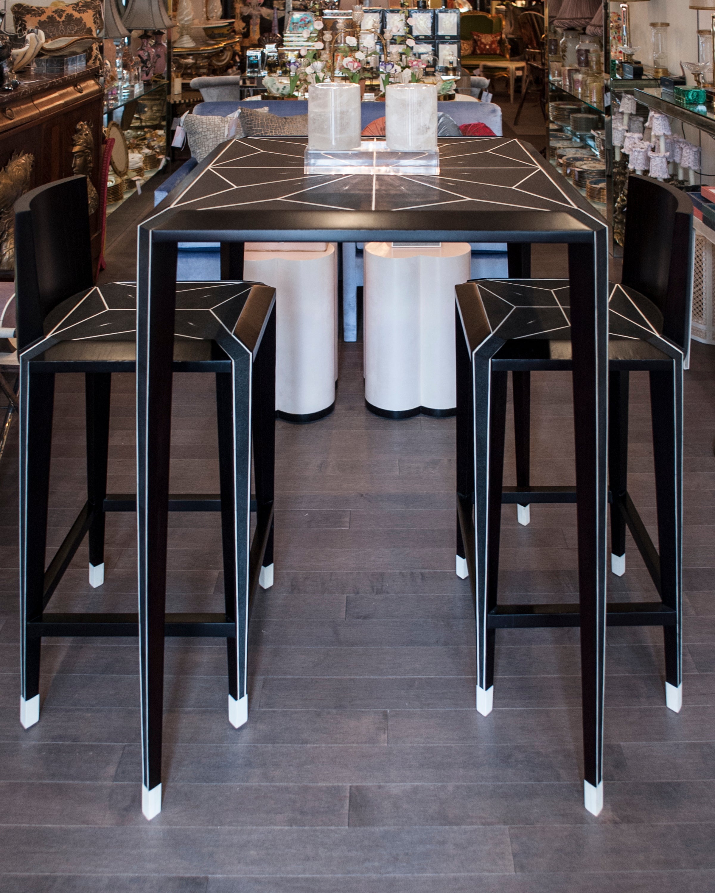 Enjoy sipping on your favourite cocktail while seated at this Shagreen bar table and chairs. It’s sleek modern lines exude sophistication while the bone details add refinement. Sold as a set.
