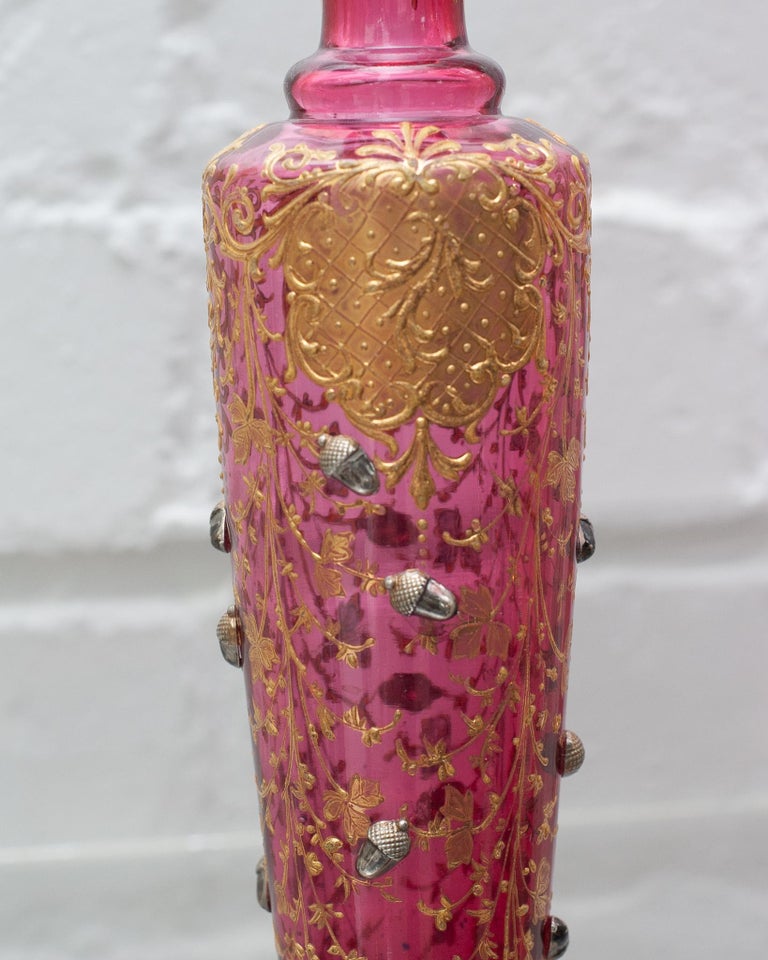 ANTIQUE MOSER CRANBERRY BUD VASE WITH GILDING AND ACORNS